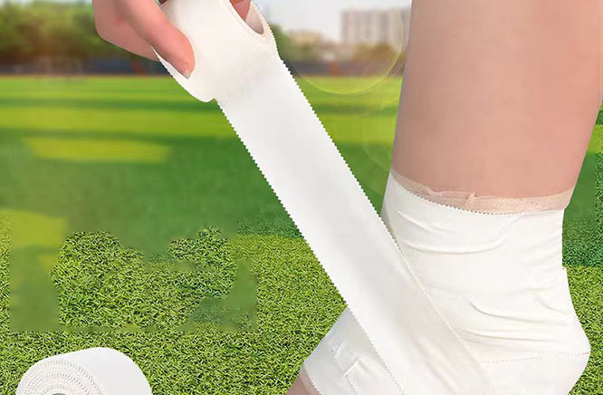 Athletic sports tape wrapped around ankle for joint support and injury protection during sports