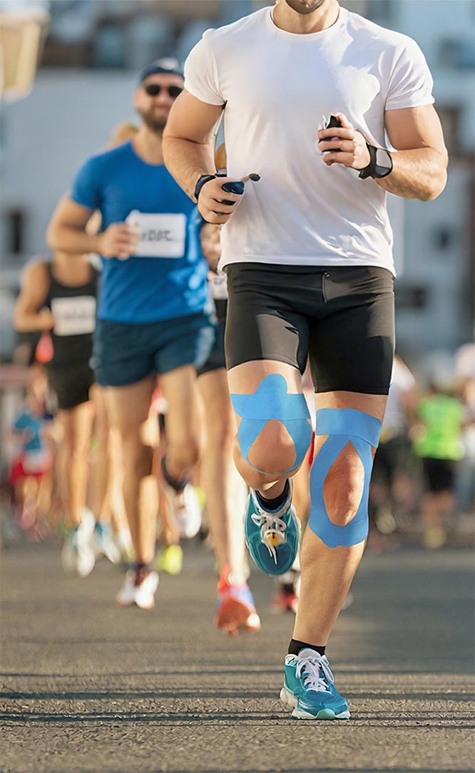 Kinesiology tape is applied to the knees to provide support, stability, and reduce strain during running